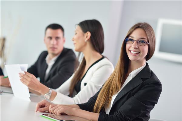 Three people sitting at a table together.